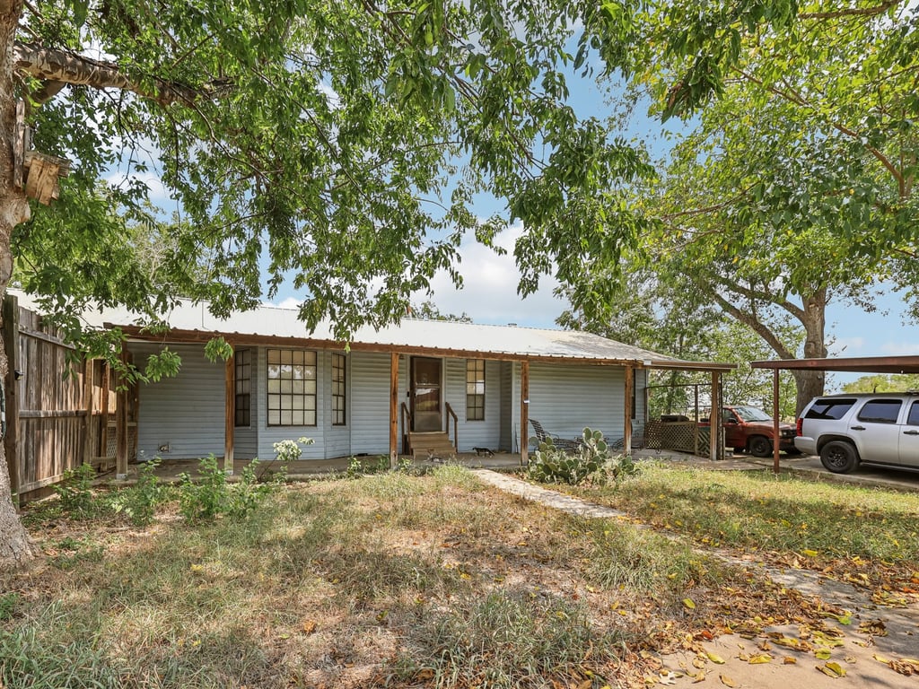 Tbd Tbd Bluebonnet Road Lockhart, TX 78644 - Photo 18 of 20 a front view of a house with a yard and garage