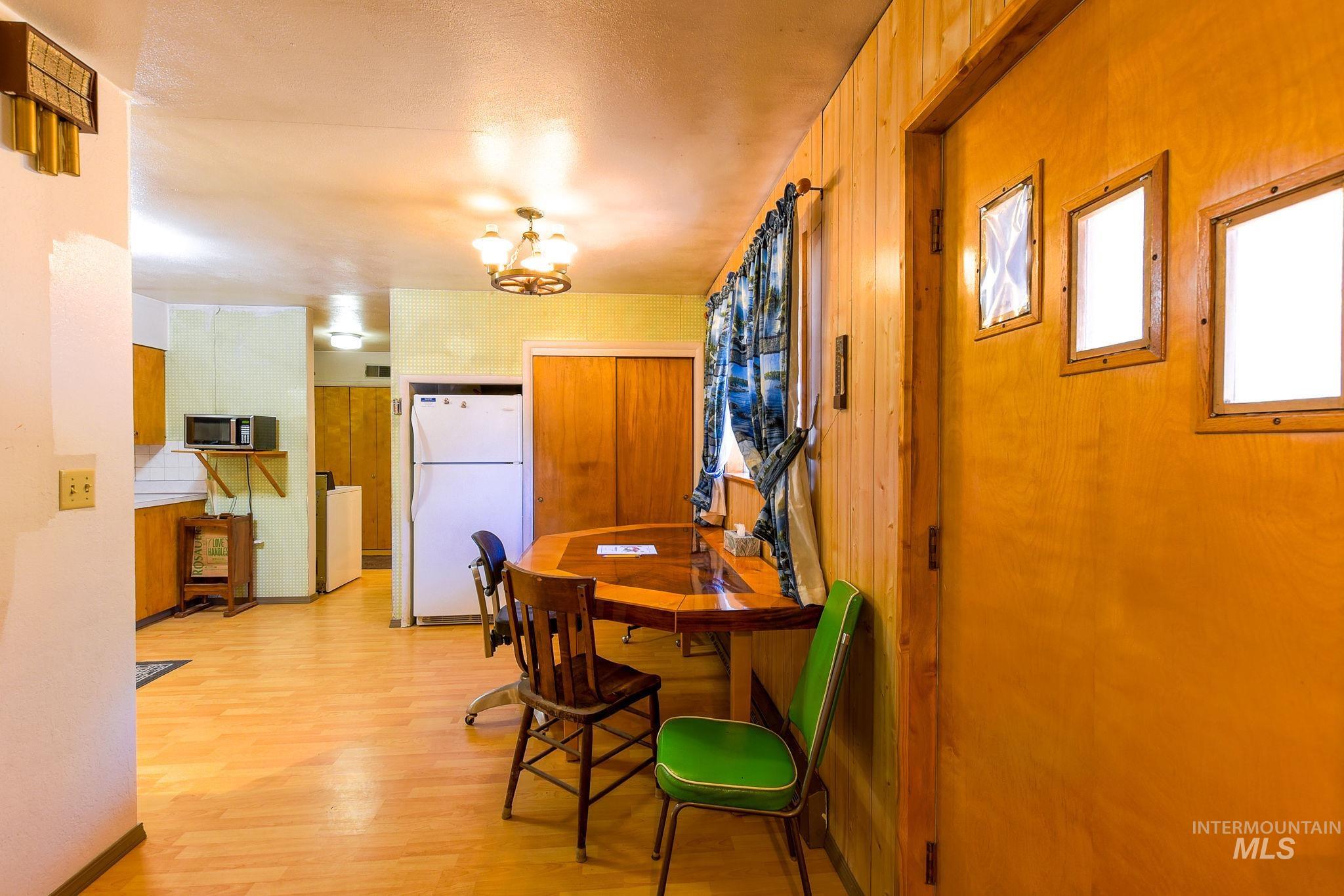 243 North Fir Street Genesee, ID 83832 - Photo 13 of 50 Dining room featuring light wood-type flooring and a chandelier