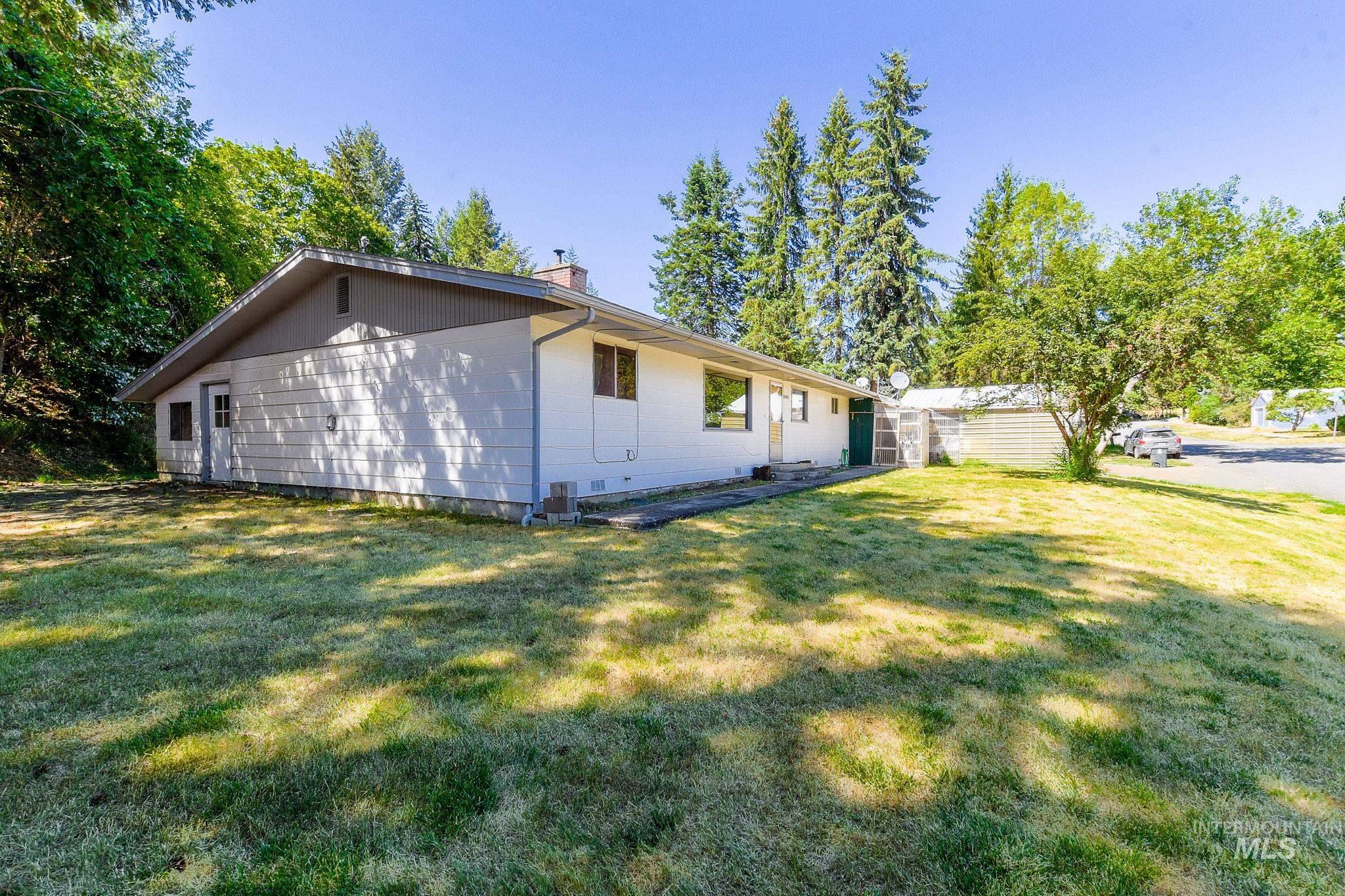 243 North Fir Street Genesee, ID 83832 - Photo 50 of 50 View of side of home with a chimney and a yard