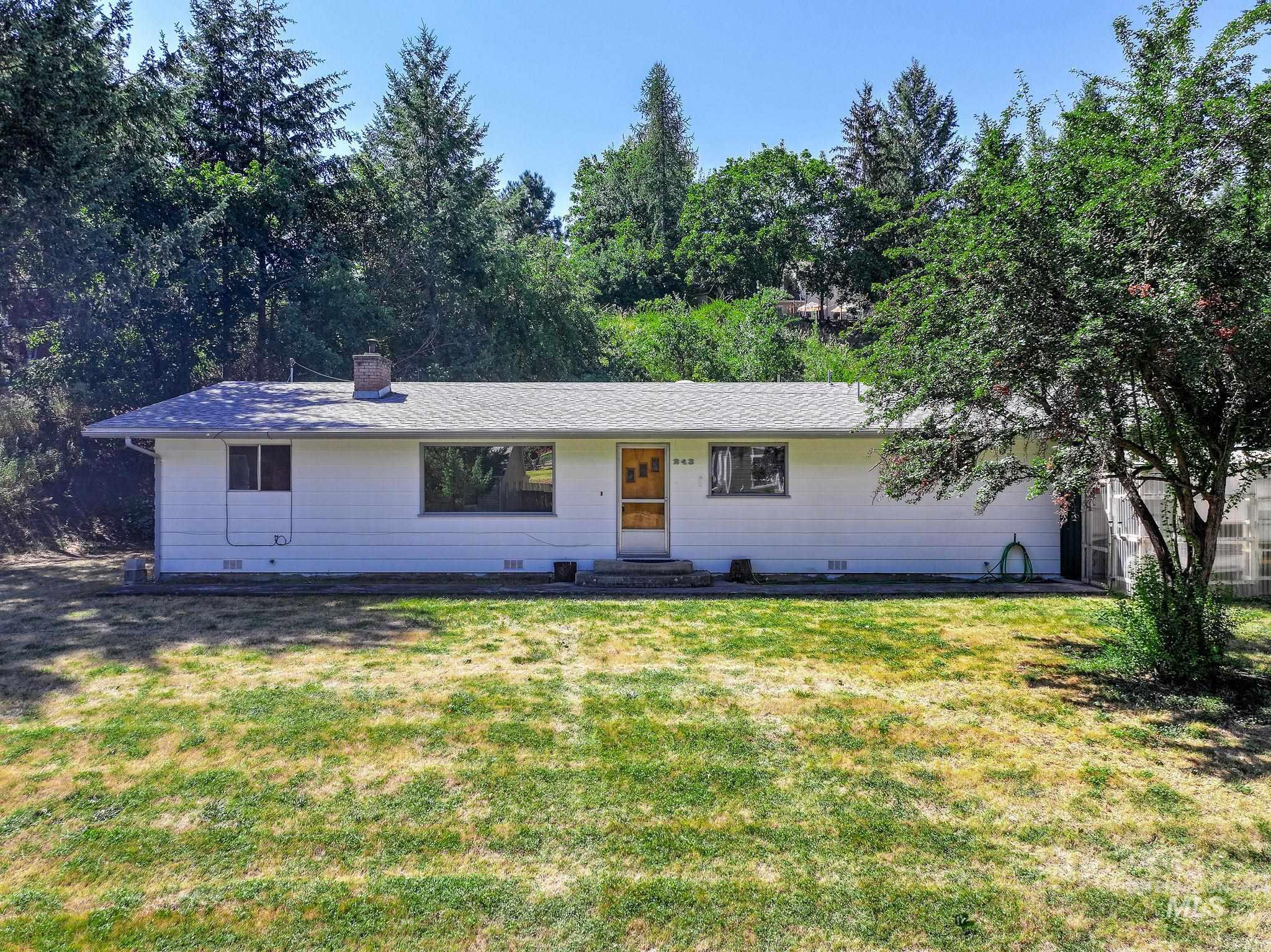 243 North Fir Street Genesee, ID 83832 - Photo 5 of 50 Ranch-style house with a front yard, a chimney, crawl space, and entry steps