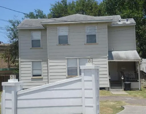 a view of a house with a balcony and door