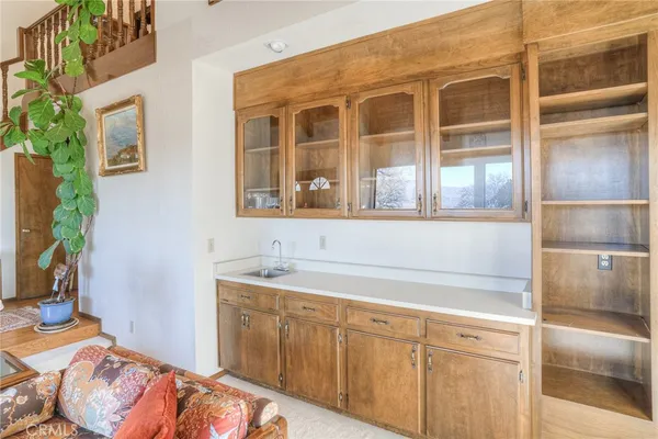 a kitchen with a table chairs refrigerator and microwave