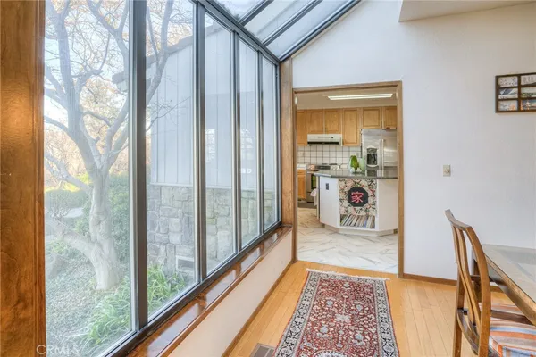 a kitchen with stainless steel appliances granite countertop a stove a refrigerator a oven a sink with a dining table and chairs