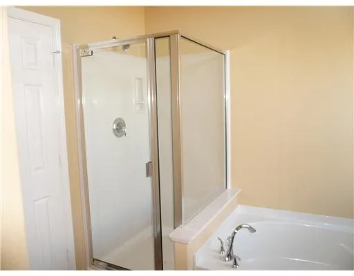 a bathroom with a shower and a sink