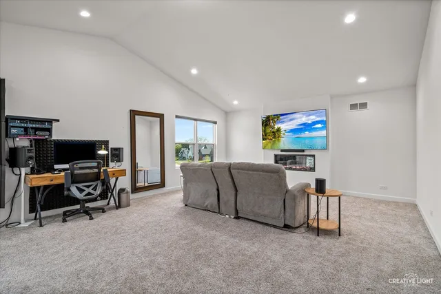 a living room with furniture a projector and a flat screen tv