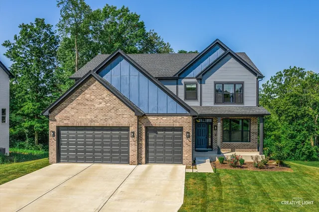a front view of a house with a yard and porch