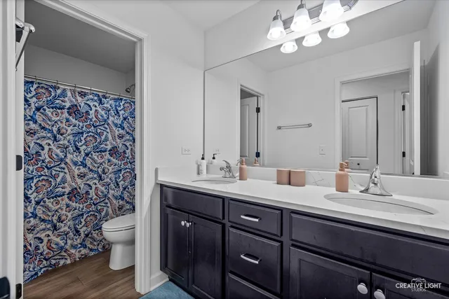 a bathroom with a double vanity sink and a mirror
