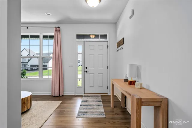 a view of an entryway with wooden floor