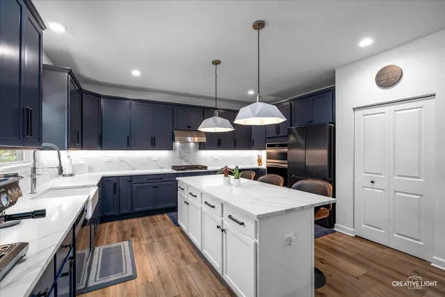 a kitchen with a sink stove and refrigerator
