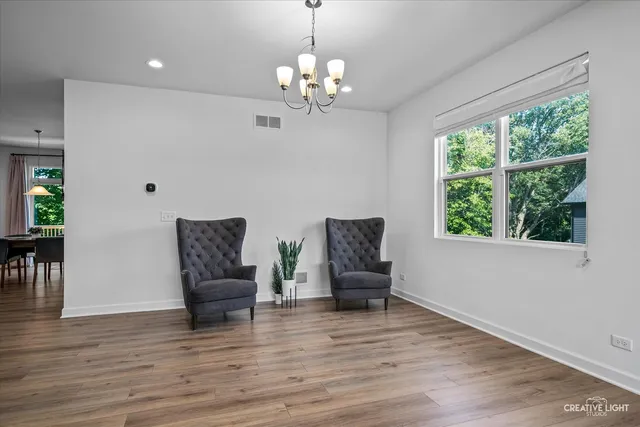 a living room with furniture and a chandelier