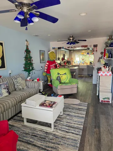 a living room with furniture fireplace and wooden floor