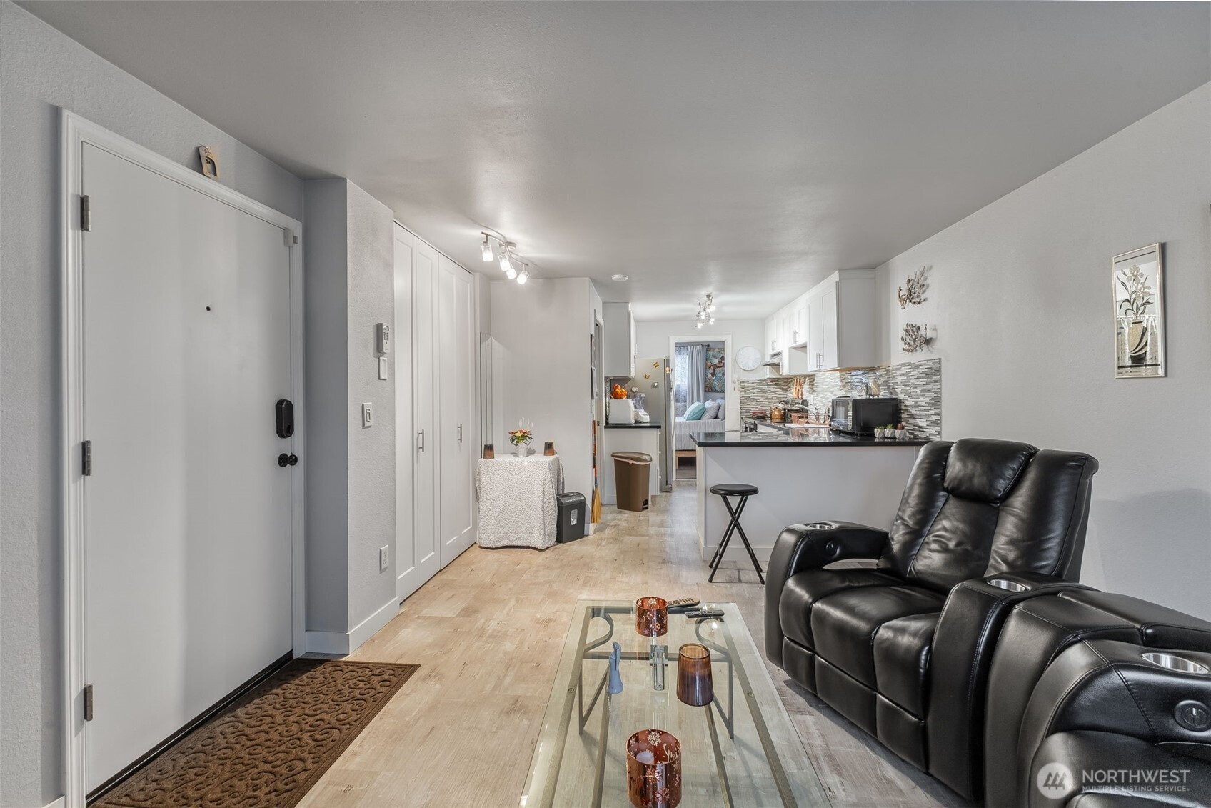 12434 Ambaum Boulevard Southwest, Unit 114 Burien, WA 98146 - Photo 7 of 18 a living room with furniture and a rug