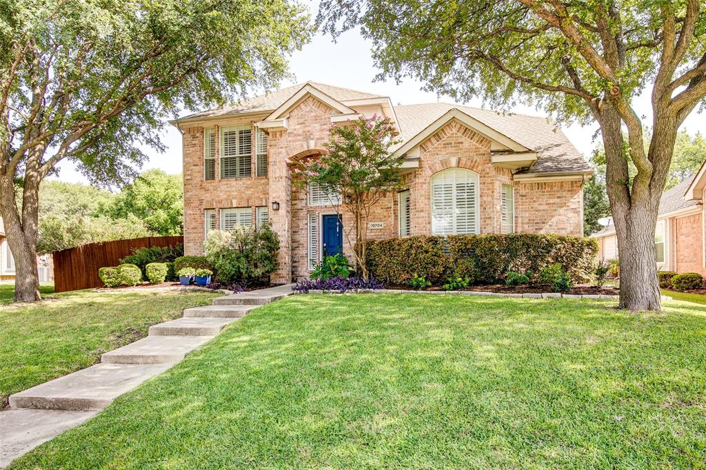 10704 Tree Shadow Lane Frisco, TX 75035 - Photo 1 of 1 a front view of a house with a yard and trees