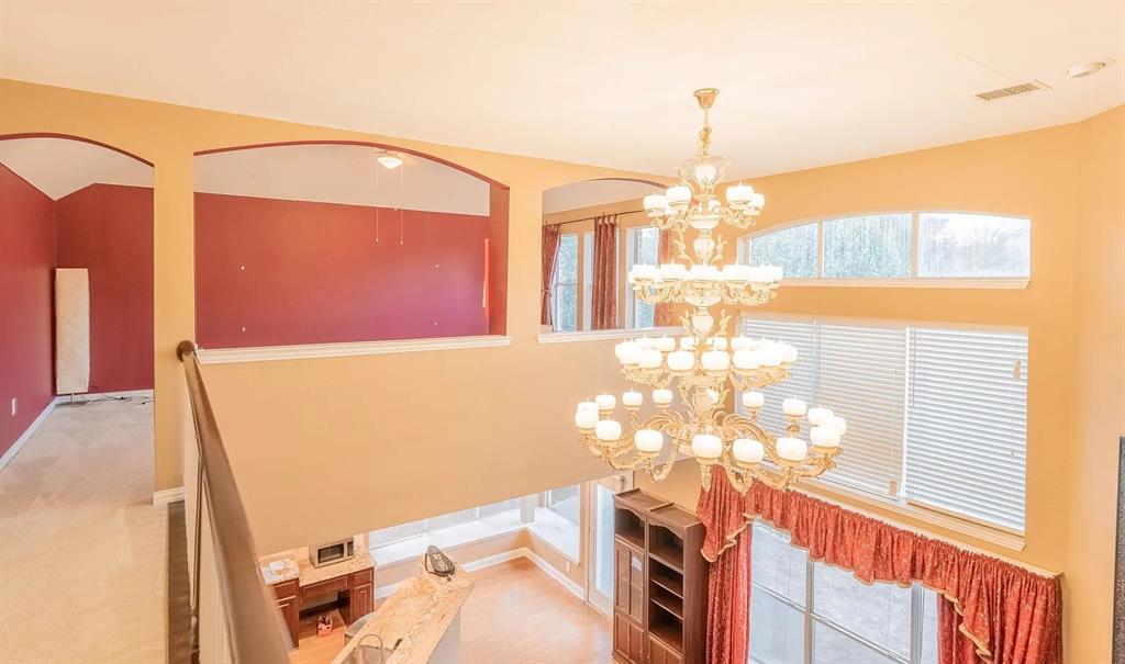 3829 Walnut Ridge Lane Plano, TX 75074 - Photo 5 of 18 a view of a dining room with furniture and chandelier