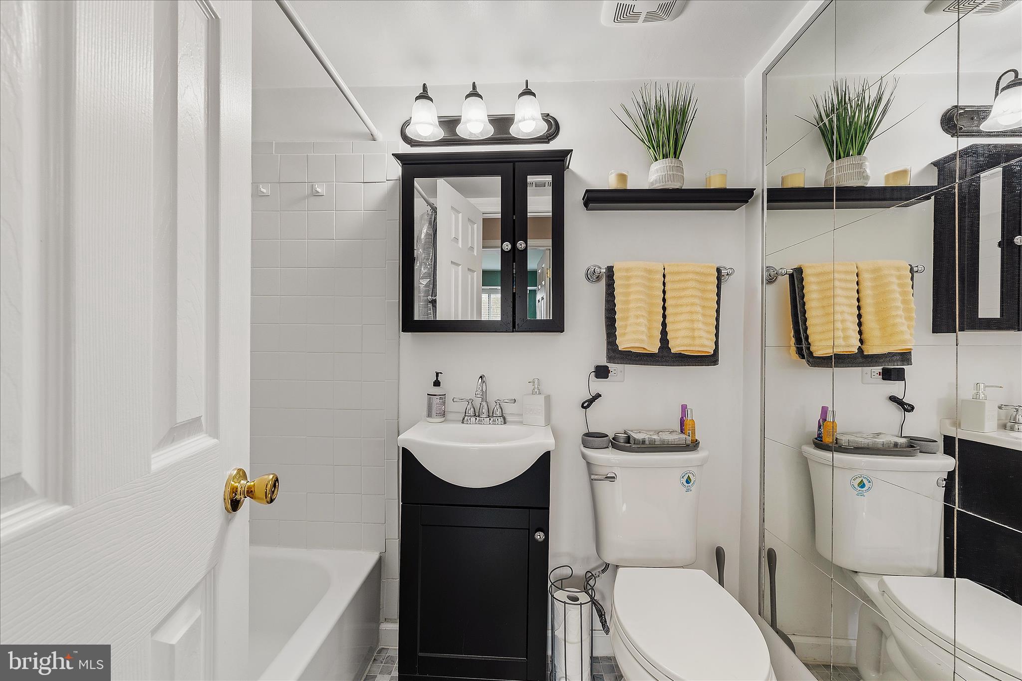 11334 Cherry Hill Road, Unit 2J20 Beltsville, MD 20705 - Photo 23 of 39 a bathroom with a toilet sink and mirror