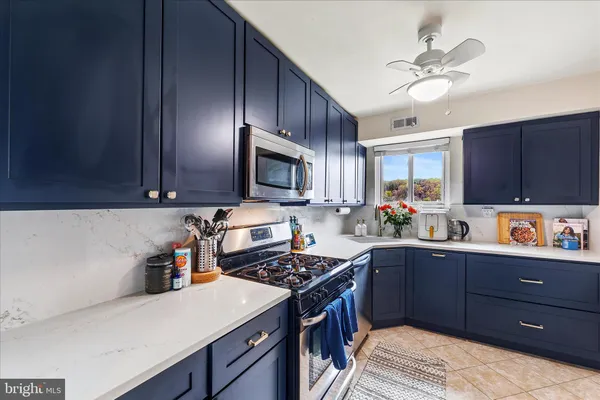 a kitchen with a sink a stove and cabinets