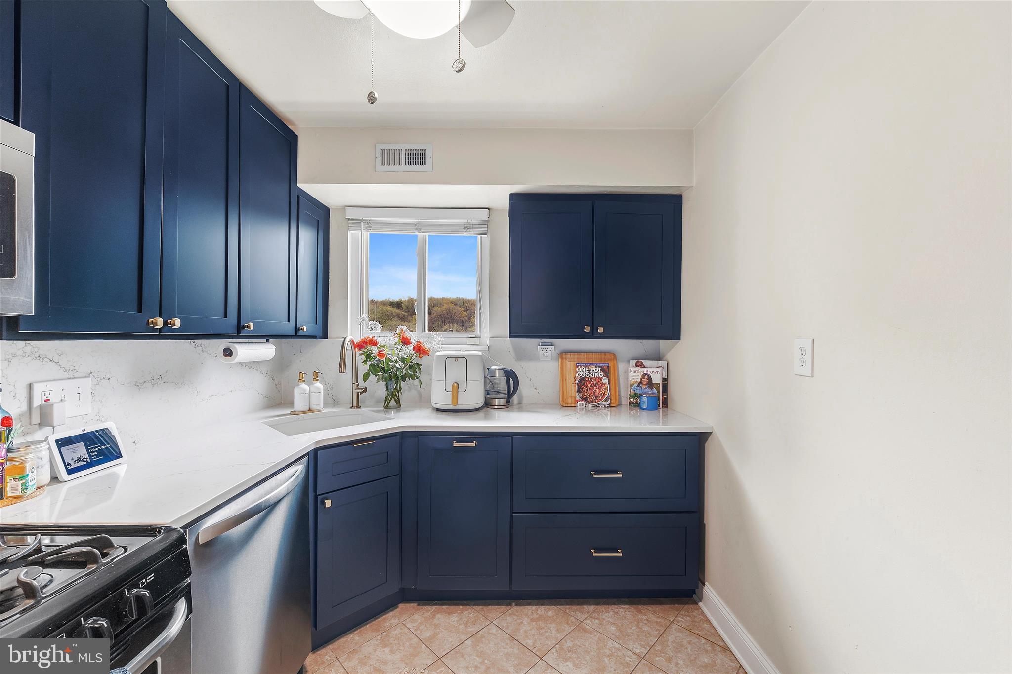 11334 Cherry Hill Road, Unit 2J20 Beltsville, MD 20705 - Photo 5 of 39 a kitchen with a cabinets and window