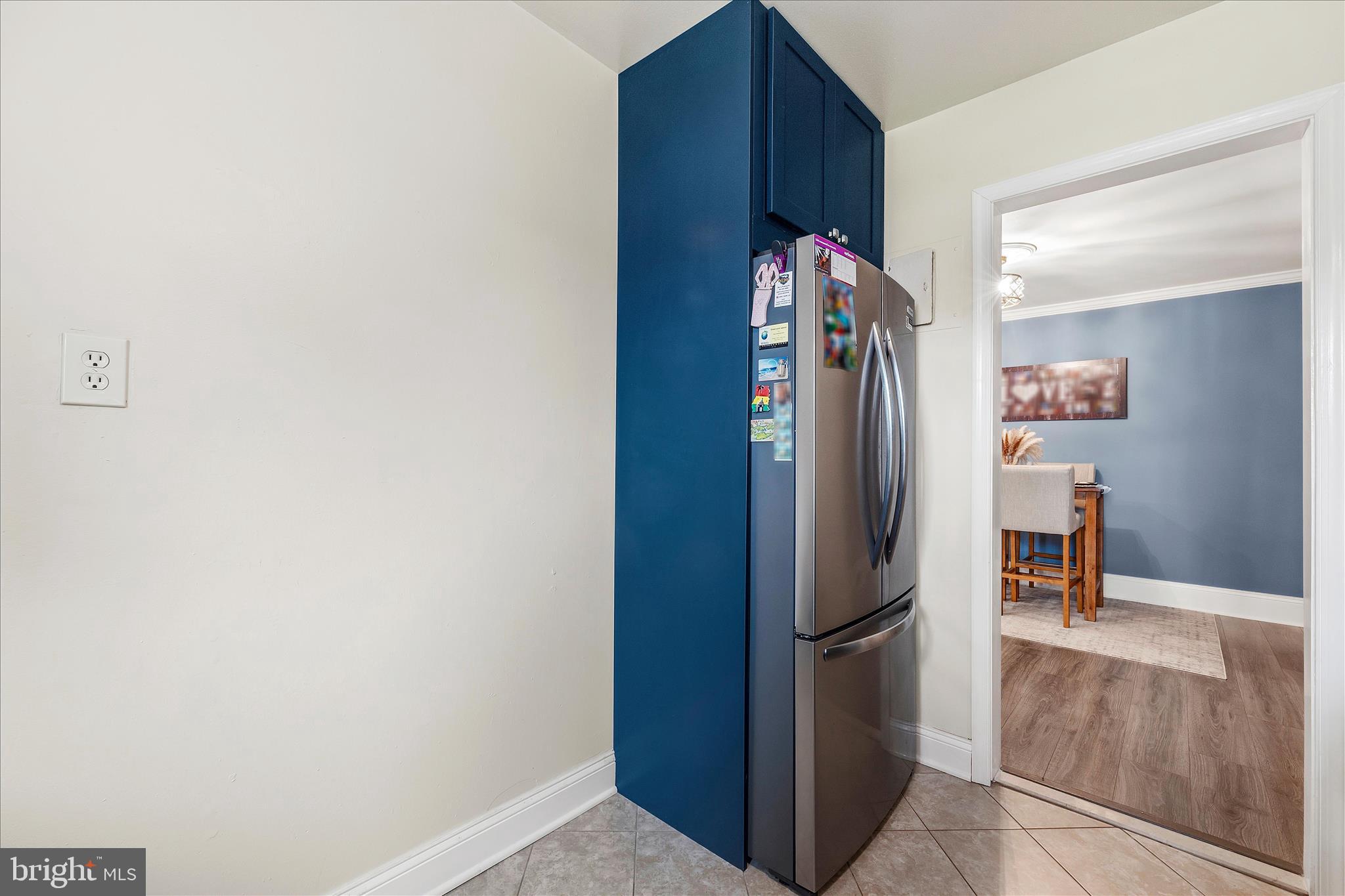 11334 Cherry Hill Road, Unit 2J20 Beltsville, MD 20705 - Photo 10 of 39 a view of a refrigerator in kitchen and an empty room