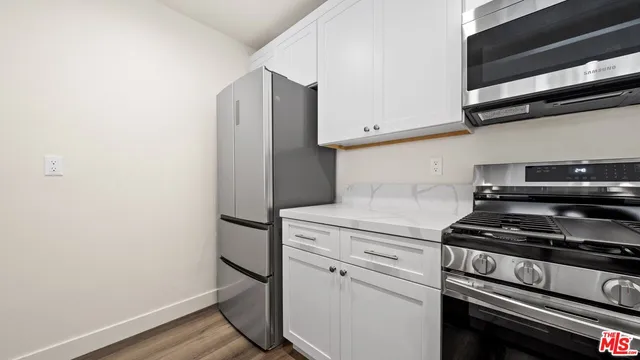a kitchen with a stove and a refrigerator