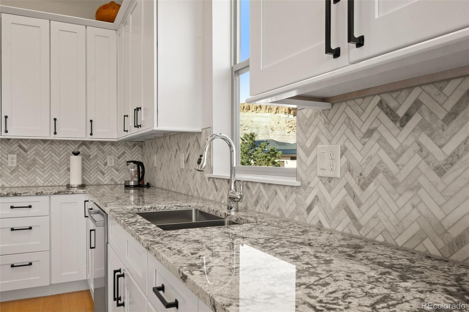 2287 Rock Valley Road Grand Junction, CO 81507 - Photo 11 of 32 a kitchen with a sink stove and cabinets