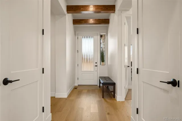 a view of a room with wooden floor and a bathroom