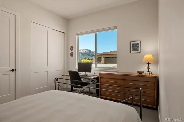 a bedroom with a bed and a dresser in it