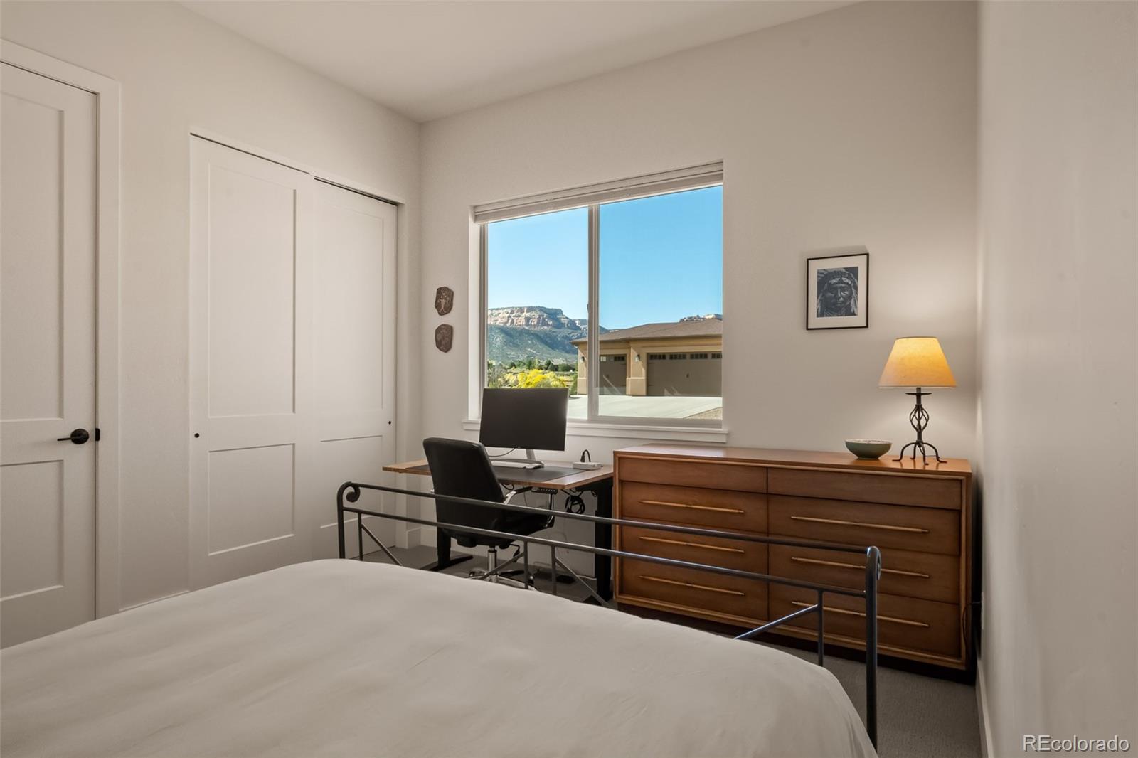 2287 Rock Valley Road Grand Junction, CO 81507 - Photo 21 of 32 a bedroom with a bed and a dresser in it