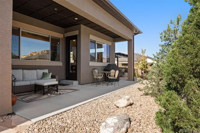 a living room with a couch and a potted plant