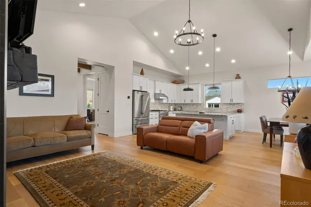a living room with furniture and a dining table