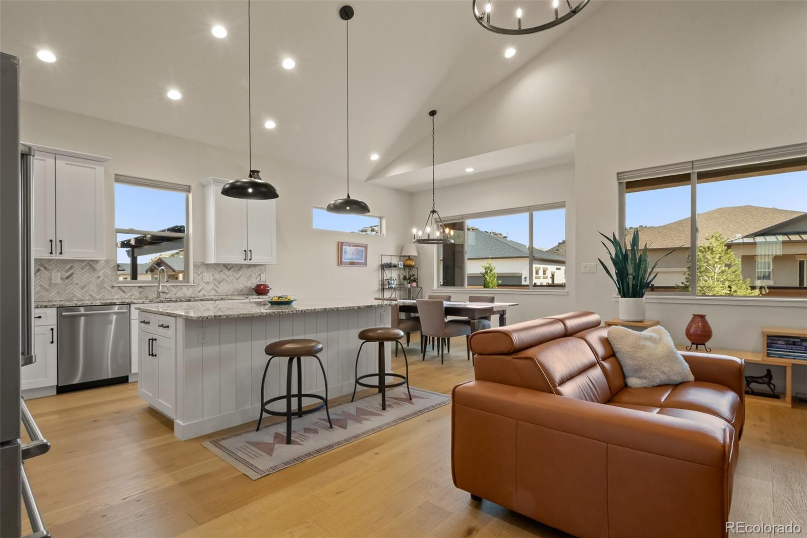 2287 Rock Valley Road Grand Junction, CO 81507 - Photo 7 of 32 a living room with stainless steel appliances kitchen island granite countertop a stove a sink a oven and a view of living room