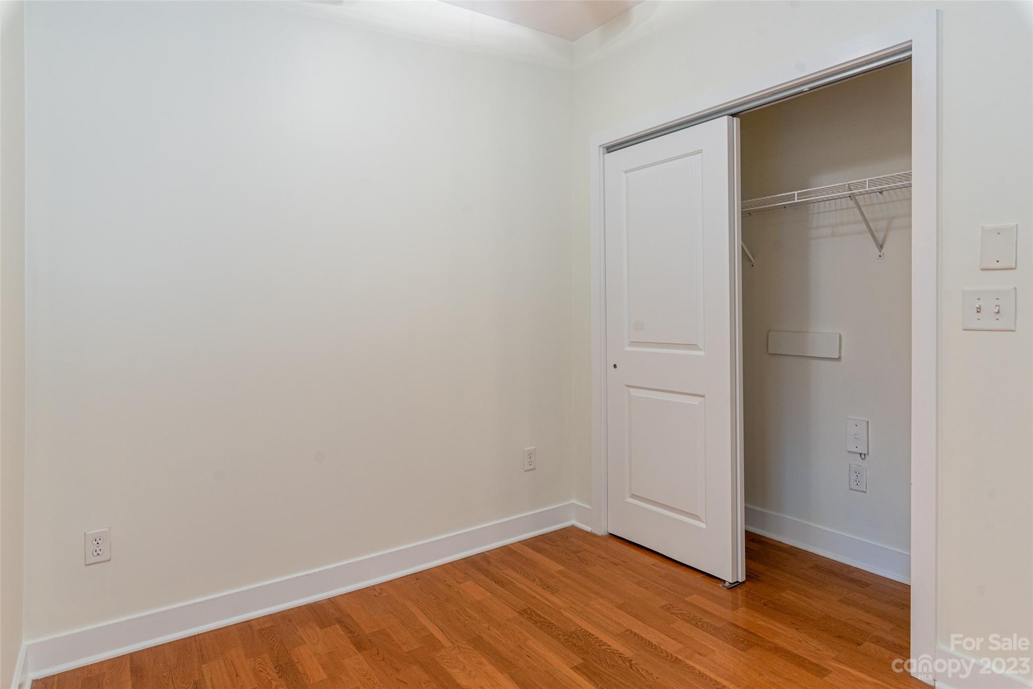 630 Calvert Street, Unit 307 Charlotte, NC 28208 - Photo 11 of 27 a view of an empty room with wooden floor