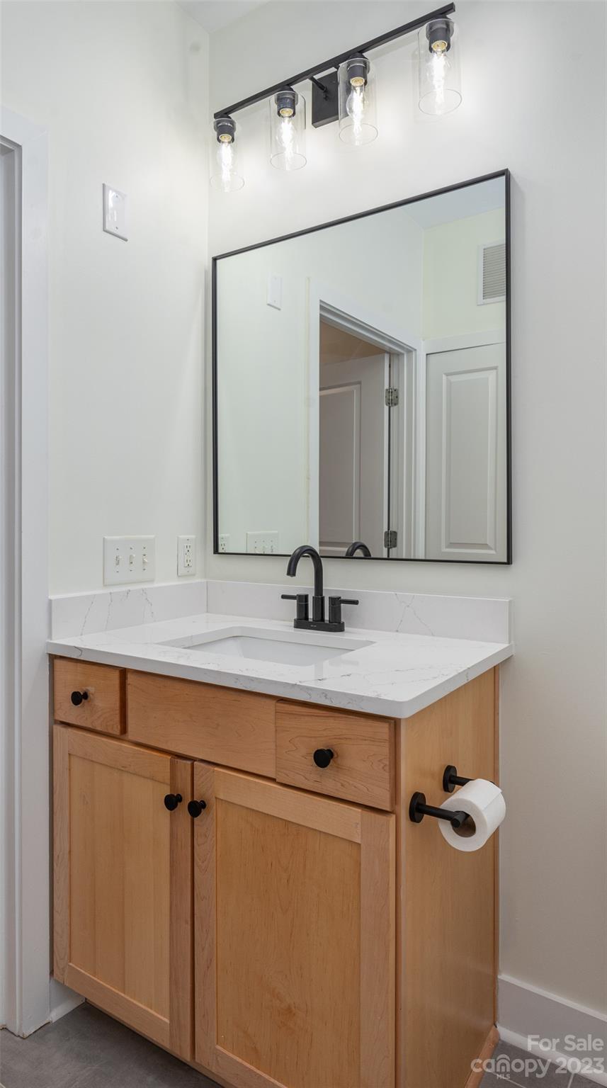 630 Calvert Street, Unit 307 Charlotte, NC 28208 - Photo 16 of 27 a bathroom with a sink and a mirror