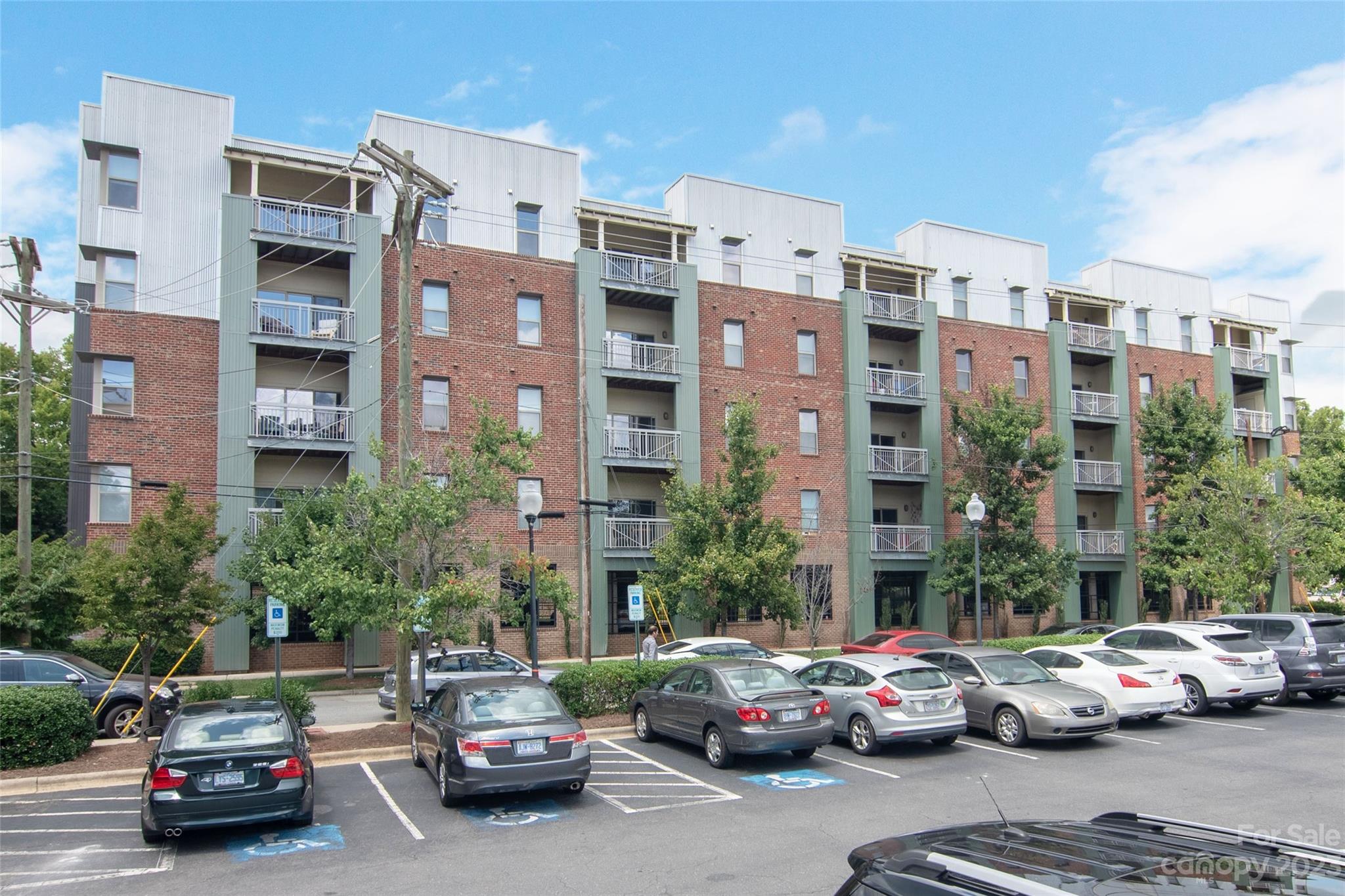 630 Calvert Street, Unit 307 Charlotte, NC 28208 - Photo 20 of 27 a cars parked in front of a building