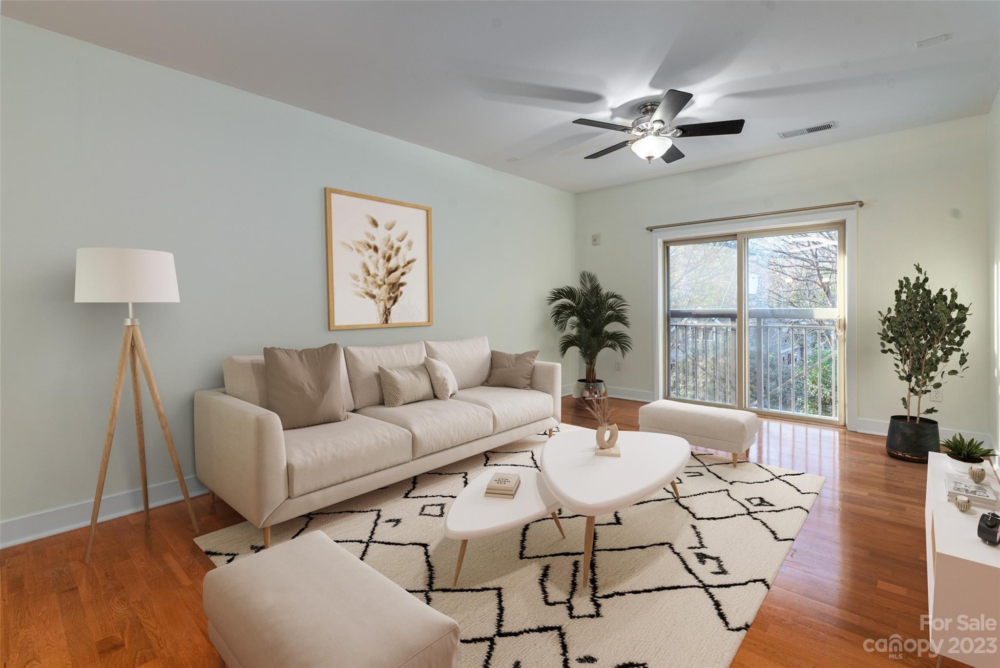 630 Calvert Street, Unit 307 Charlotte, NC 28208 - Photo 2 of 27 a living room with furniture and a large window