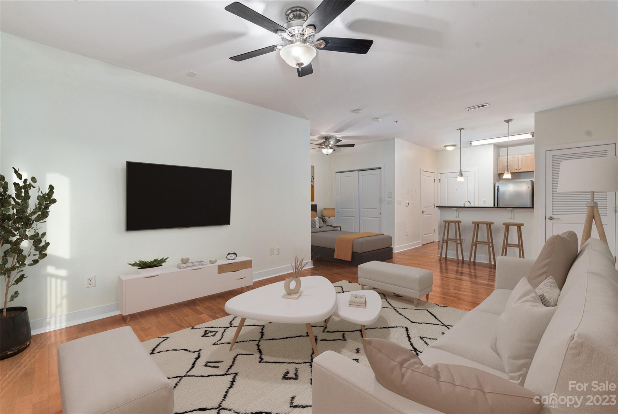 630 Calvert Street, Unit 307 Charlotte, NC 28208 - Photo 4 of 27 a living room with furniture and a flat screen tv