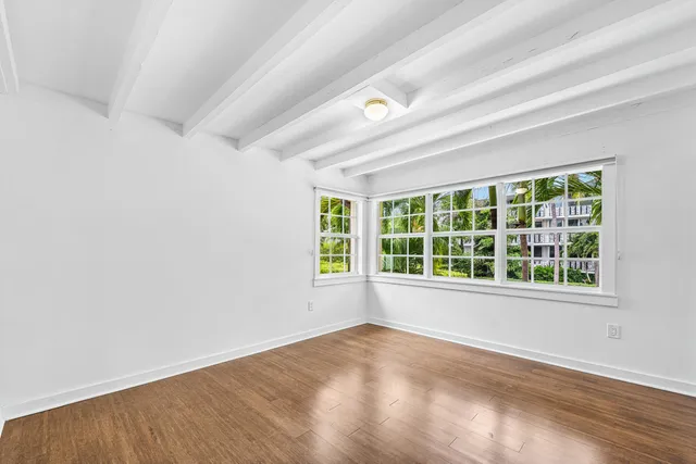 an empty room with a empty space and windows