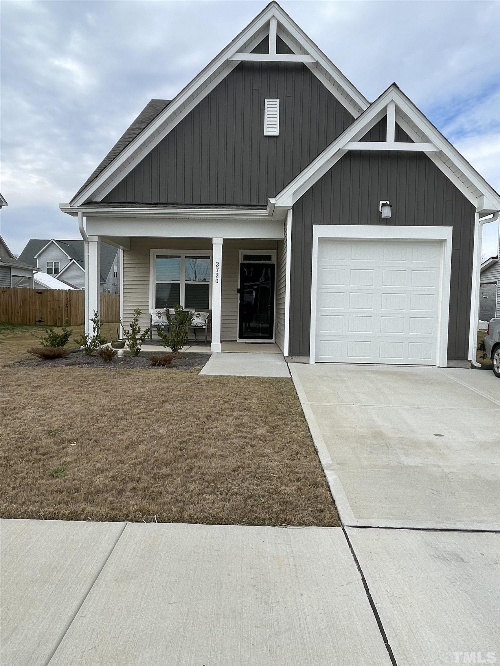 3720 Putman Road Raleigh, NC 27610 - Photo 1 of 9 a front view of a house with a yard and garage