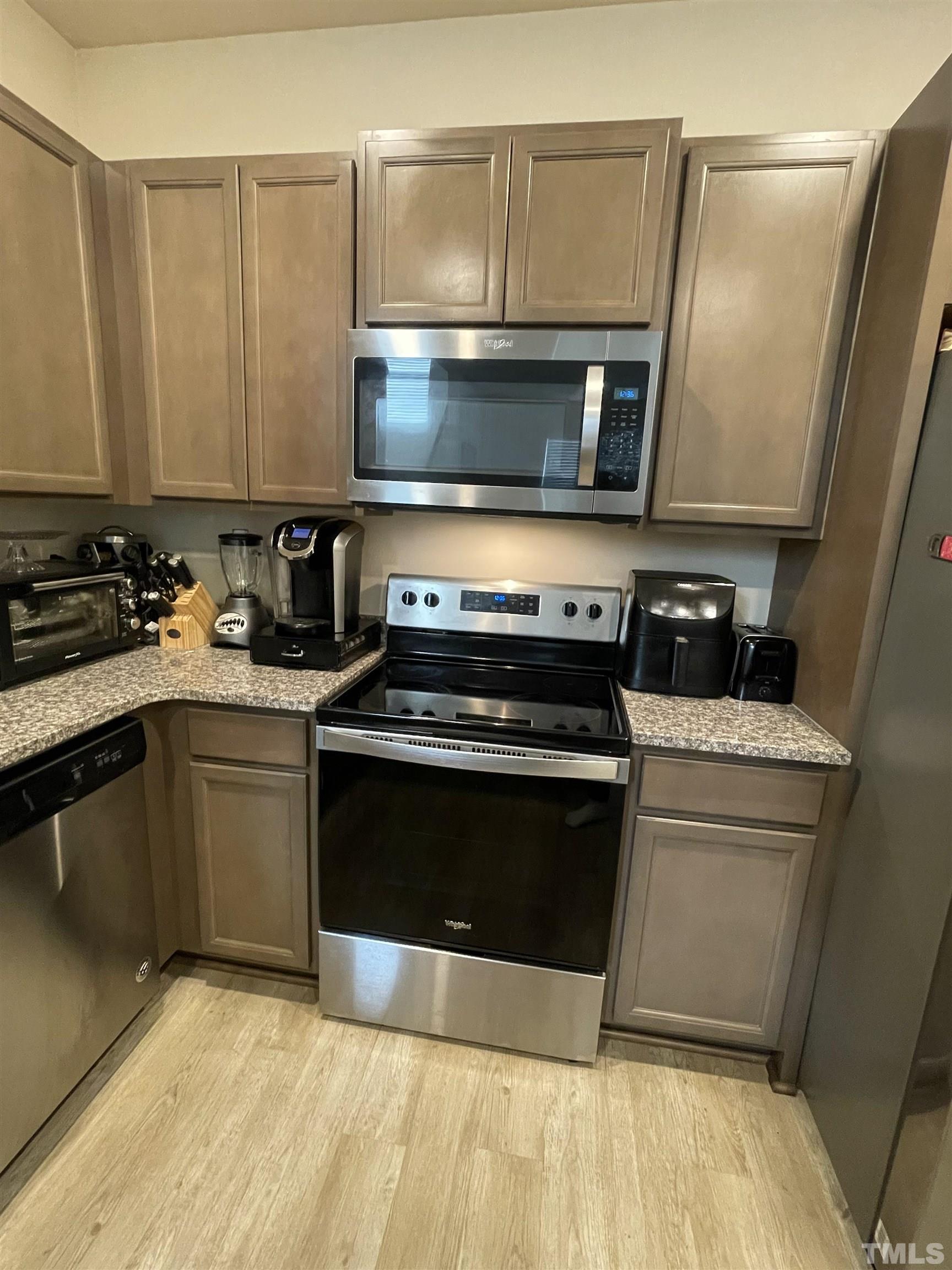 3720 Putman Road Raleigh, NC 27610 - Photo 5 of 9 a kitchen with a stove and a microwave
