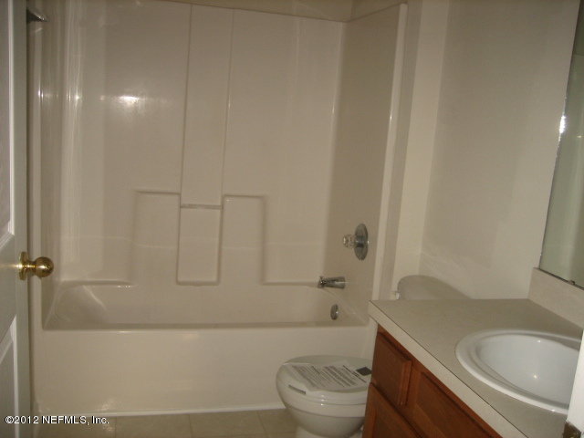 7920 Merrill Road, Unit 1501 Jacksonville, FL 32277 - Photo 8 of 11 a bathroom with a sink a toilet and bathtub
