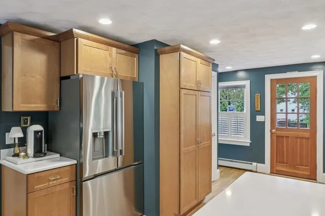 a kitchen with stainless steel appliances granite countertop a refrigerator and a sink