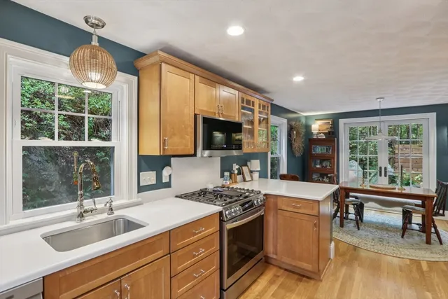 a kitchen that has a sink and a stove top oven