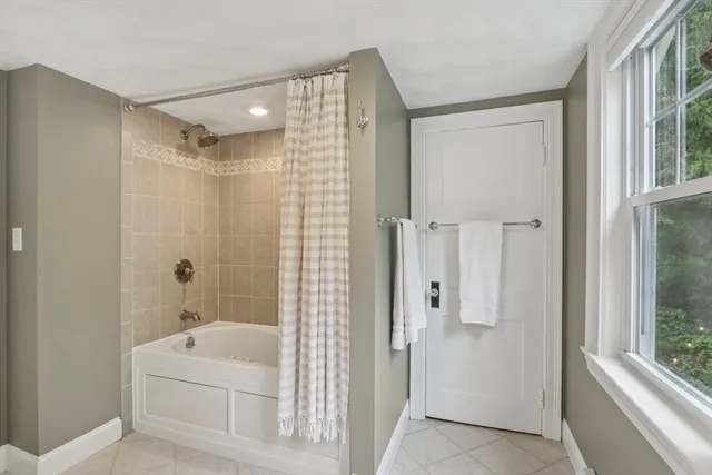 a bathroom with a shower a sink and a mirror