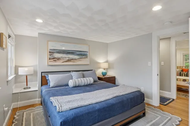 a bedroom with bed and night stand