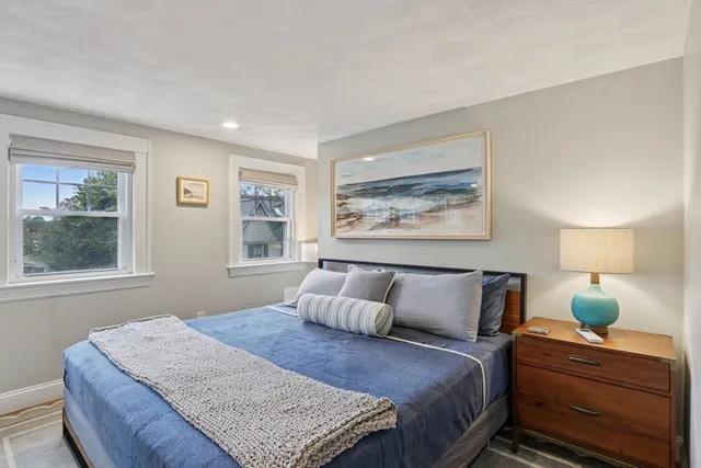 a bedroom with a bed lamp and window