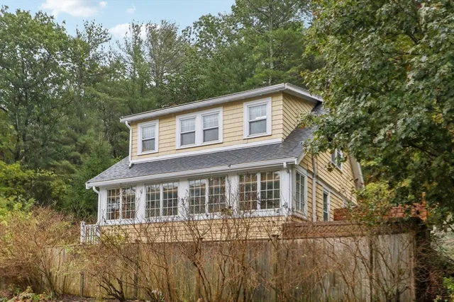 a house that has tree in front of it