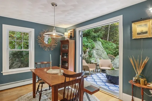 a dining room with furniture a chandelier and wooden floor