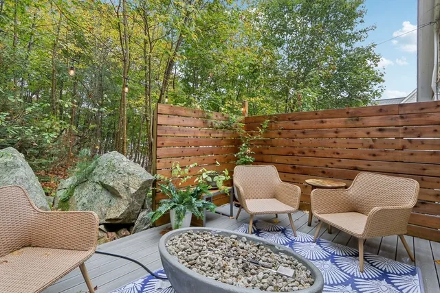 a couple of chairs sitting in a backyard of a house