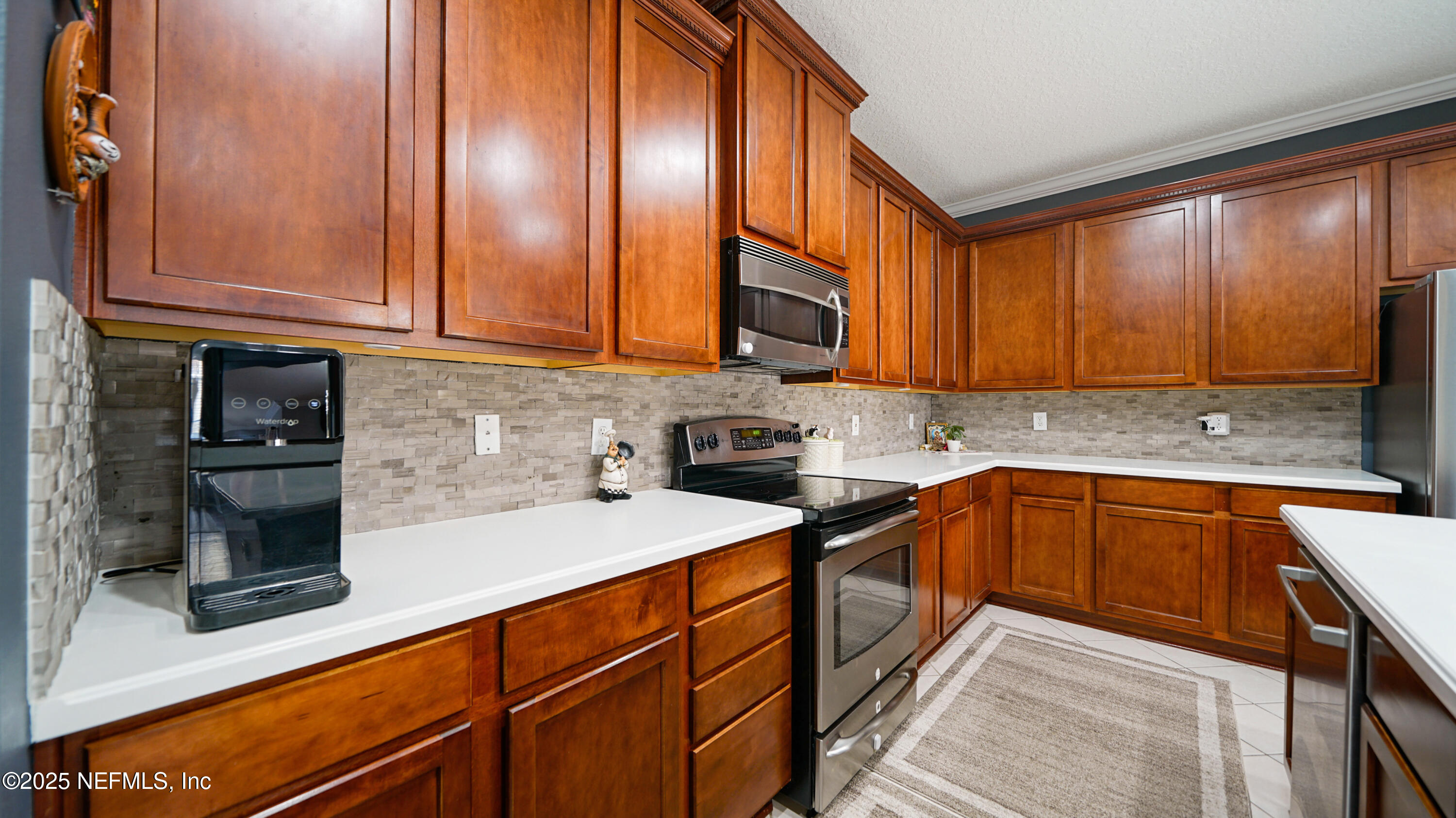 6127 Eclipse Circle Jacksonville, FL 32258 - Photo 13 of 37 a kitchen with stainless steel appliances granite countertop wooden cabinets a stove top oven a sink and dishwasher