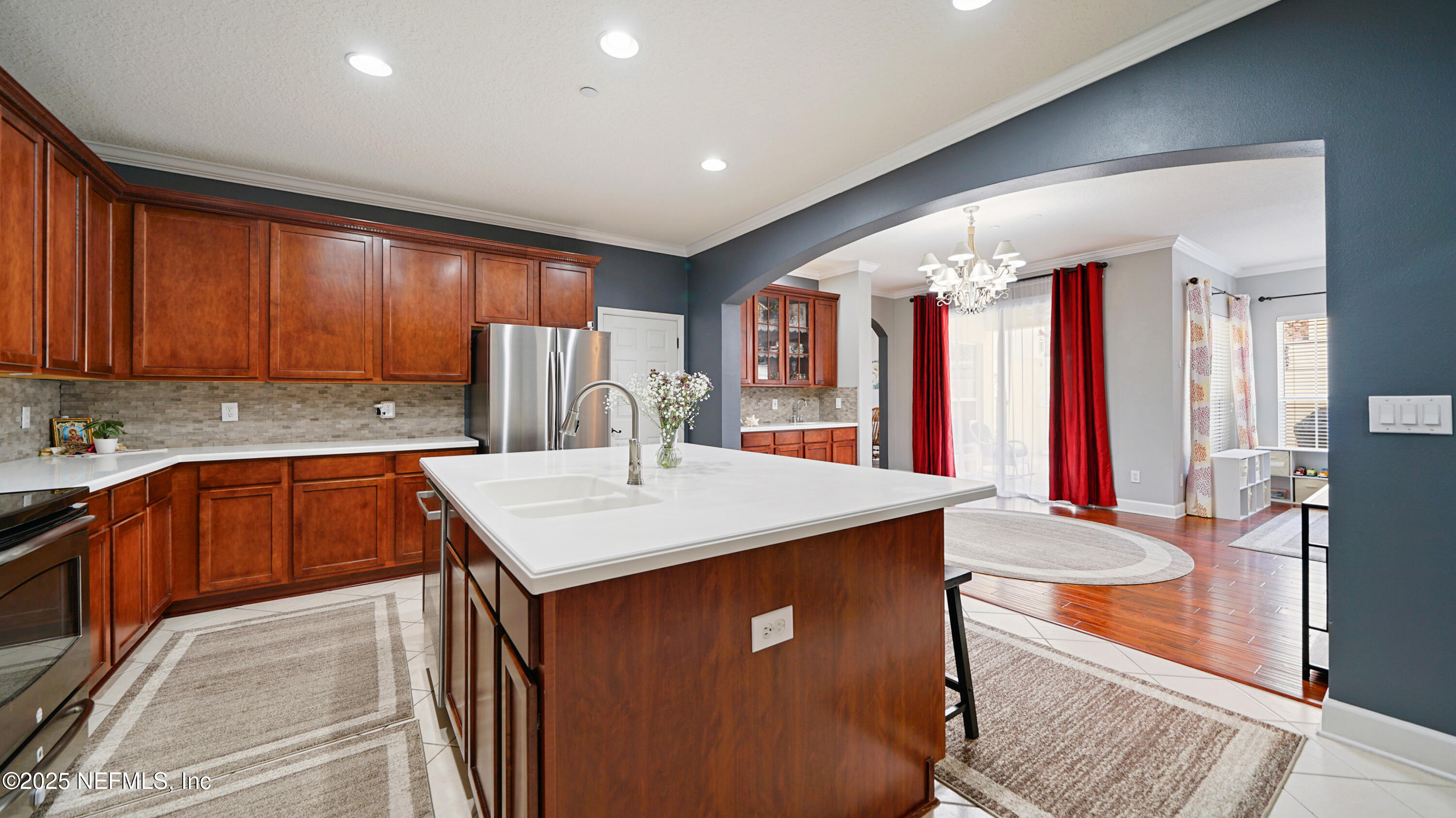 6127 Eclipse Circle Jacksonville, FL 32258 - Photo 14 of 37 a kitchen with stainless steel appliances kitchen island granite countertop a refrigerator a sink dishwasher a dining table and chairs with wooden floor