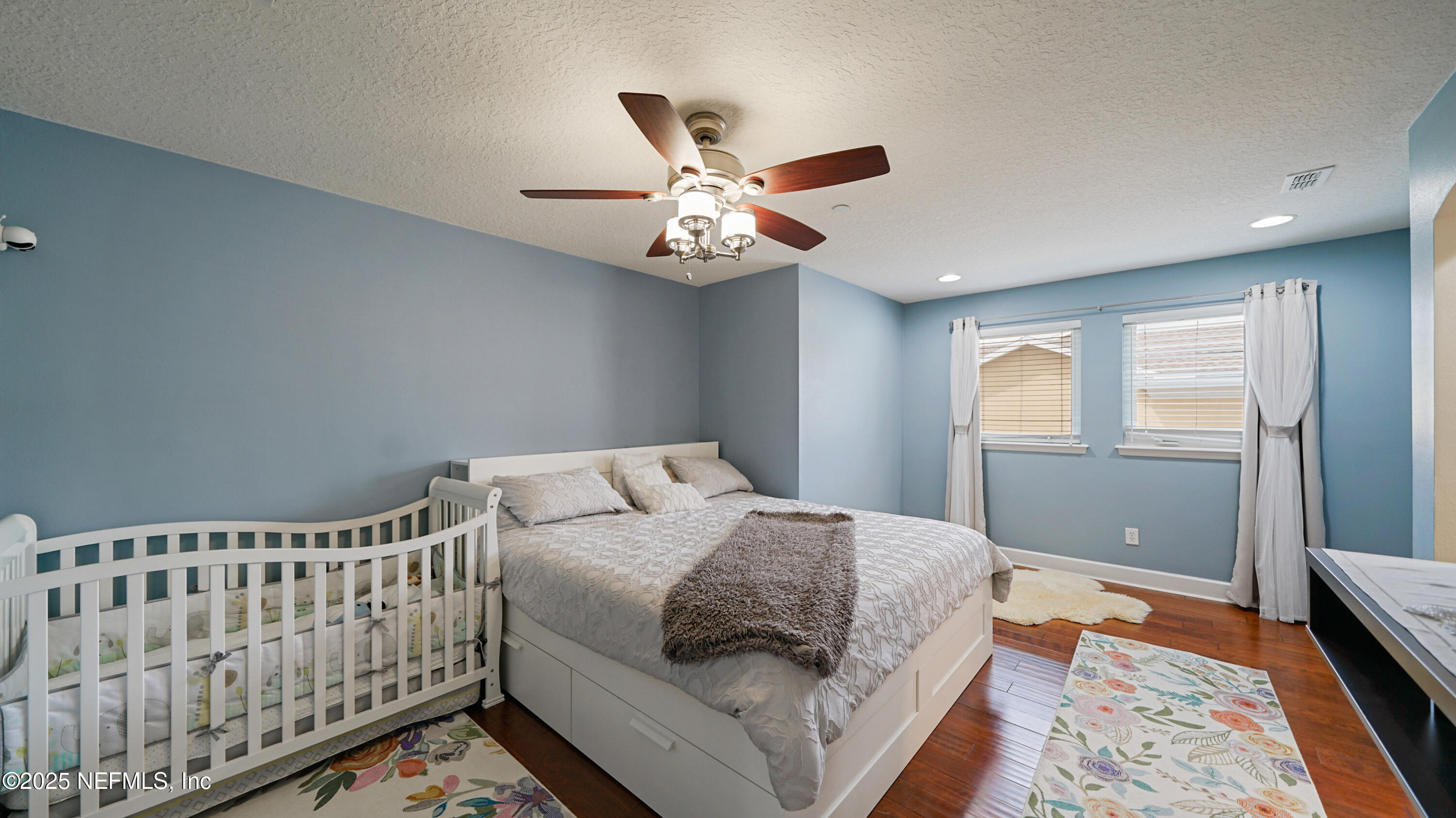 6127 Eclipse Circle Jacksonville, FL 32258 - Photo 19 of 37 a bedroom with a bed and a chandelier